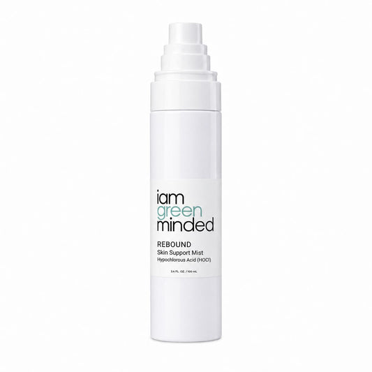 A white cylindrical pump bottle of 'i am green minded' REBOUND Skin Support Mist on a solid white background.