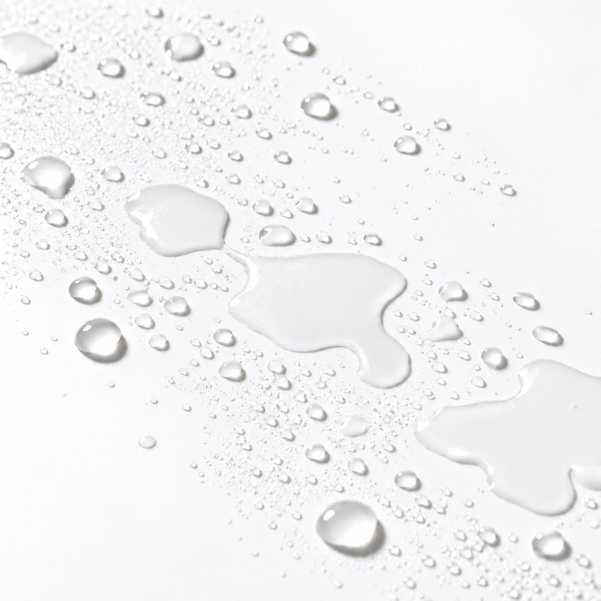 barrier mist droplets and a glossy water streak on a clean white surface, demonstrating a water-like finish