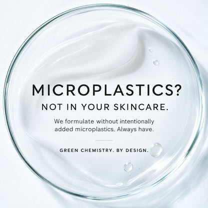 A clear glass bowl or dish containing a white cream product, photographed from above on a white background. Black text in the center reads, 'MICROPLASTICS? NOT IN YOUR SKINCARE.